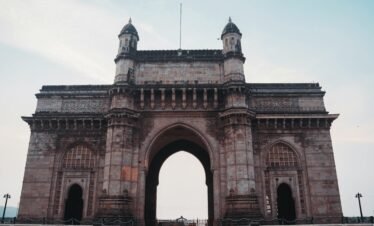 Captivating view of the historical Gateway of India monument under a clear blue sky in Mumbai.