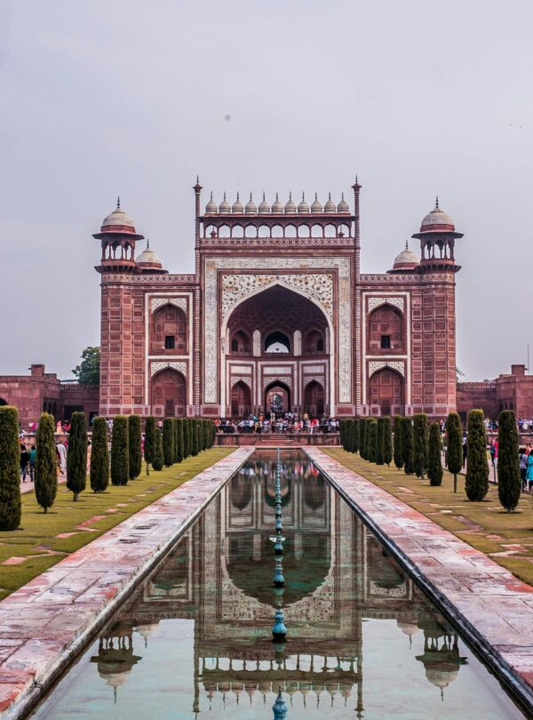 Stunning view of an Indian monument's entrance with symmetrical reflection.