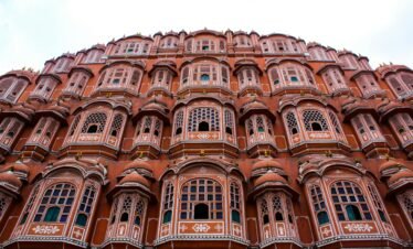 Low angle view of the iconic Hawa Mahal showcasing its elaborate facade in Jaipur, India.