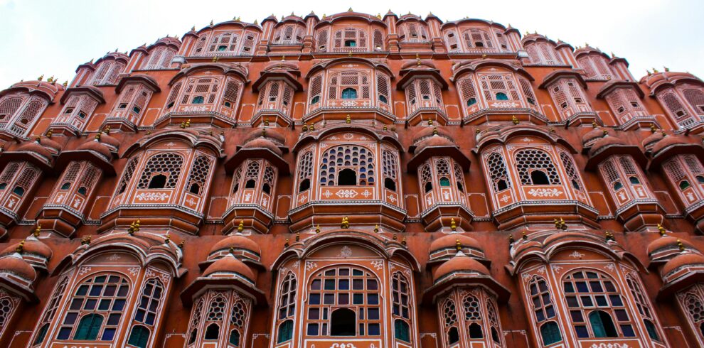 Low angle view of the iconic Hawa Mahal showcasing its elaborate facade in Jaipur, India.