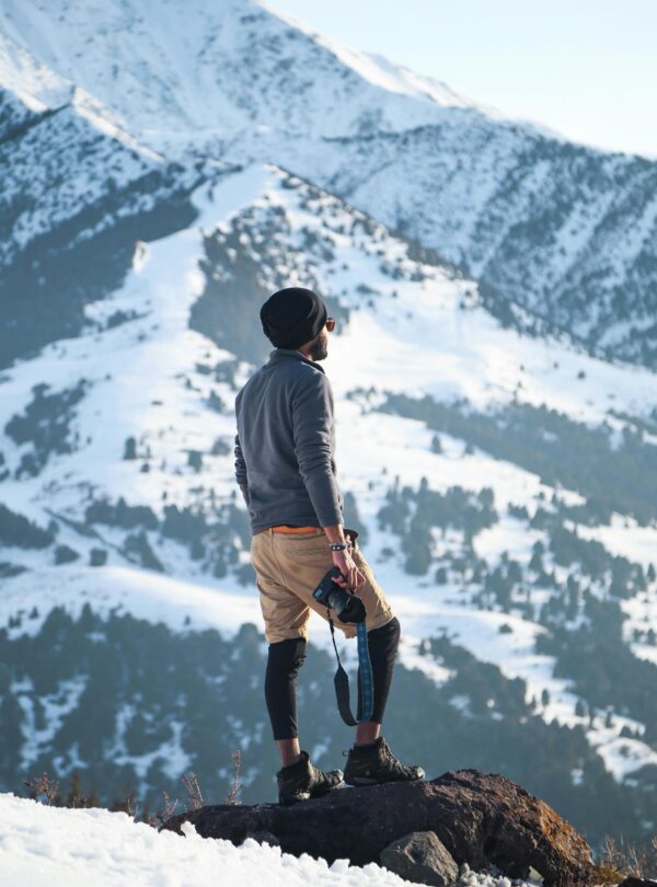 Adventurer explores snowy terrain in Ak-Talaa District, showcasing the beauty of Kyrgyzstan's winter landscape.